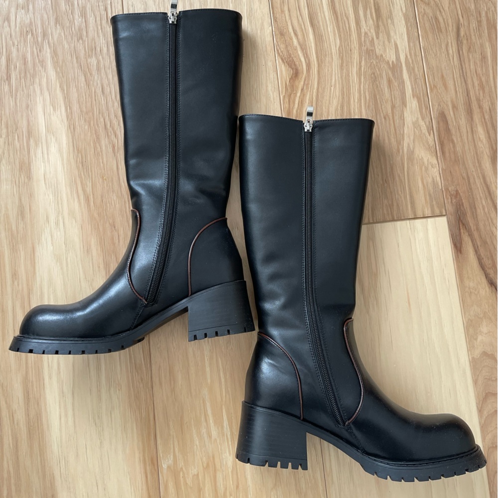 Genuine leather black knee high boots with faux fur lining.